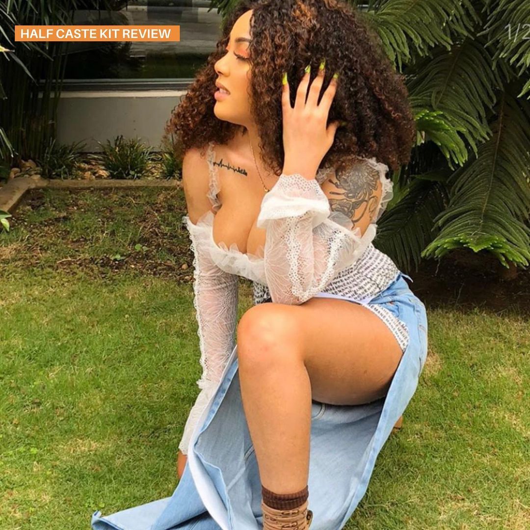 Woman with curly hair posing outdoors promoting halfcast skin care set by Bob Flawless Skincare